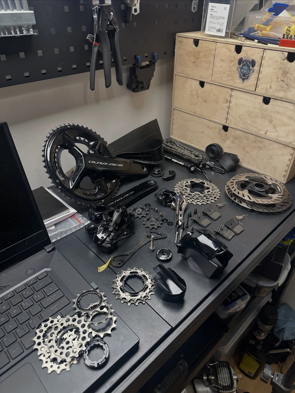 Dura-Ace cranks, cassette, brakes and bearings on the workbench