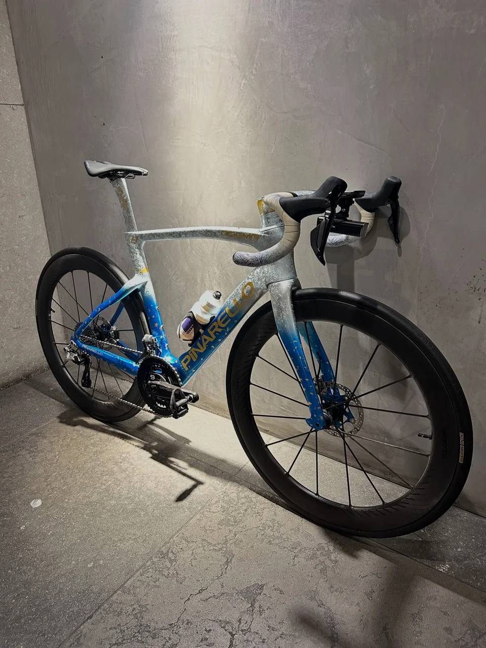 Blue-and-white Pinarello road bike after servicing at Velox